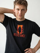 gravisk Resistance organic graphic tee. A silhouette in a burning orange doorway, RESISTANCE in red below.