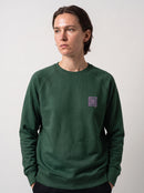 gravisk Self-Care Is Not Selfish chest print sweatshirt in organic cotton. Small lilac speech bubble on the left chest.