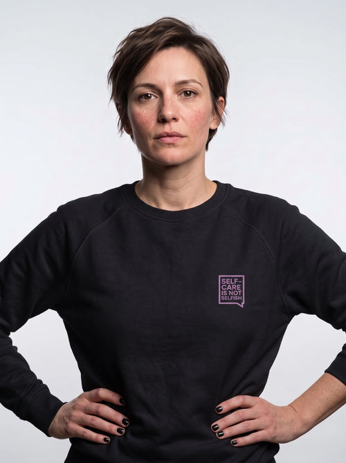 gravisk Self-Care Is Not Selfish chest print sweatshirt in organic cotton. Small lilac speech bubble on the left chest.