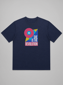 gravisk She Is the Revolution organic graphic tee. Bold geometric shapes in pink, blue and yellow around SHE IS THE REVOLUTION.