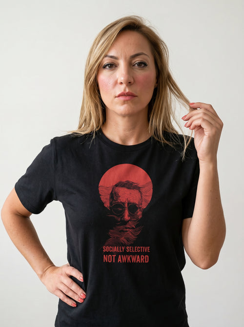 gravisk Socially Selective, Not Awkward organic graphic tee. A man in round glasses, hand over his mouth, inside a red circle.