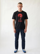 gravisk Socially Selective, Not Awkward organic graphic tee. A man in round glasses, hand over his mouth, inside a red circle.