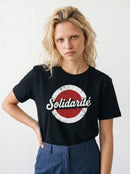 gravisk Solidarité organic graphic tee. Solidarité in white script on a worn red and white circle.