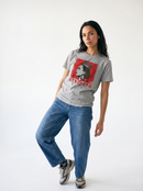 gravisk Strength organic graphic tee. A crowned profile on a distressed red square, STRENGTH in red serif.