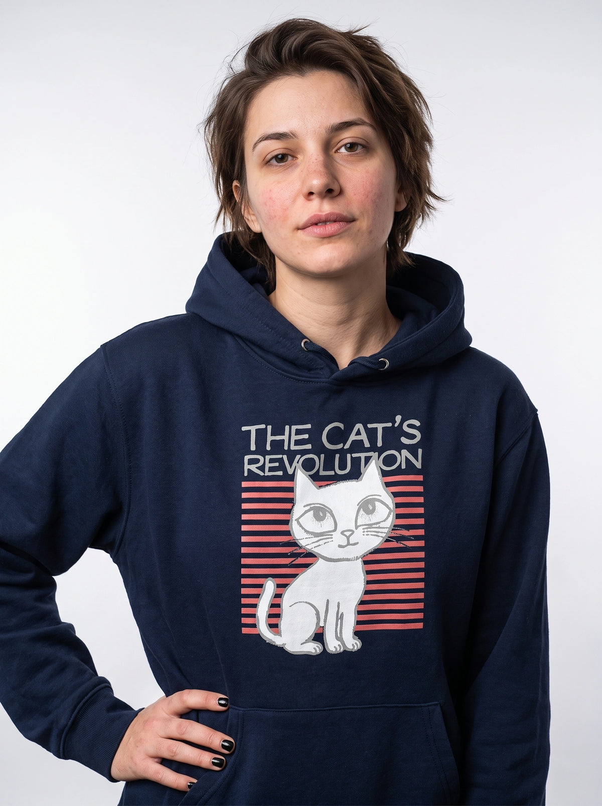 gravisk The Cat's Revolution graphic hoodie in organic cotton. Wide-eyed white cat over coral stripes with retro lettering.