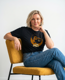 gravisk To Be Enough for What? organic graphic tee. Amber profile with a sunflower blooming from the head, TO BE ENOUGH FOR WHAT?