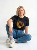 gravisk To Be Enough for What? organic graphic tee. Amber profile with a sunflower blooming from the head, TO BE ENOUGH FOR WHAT?