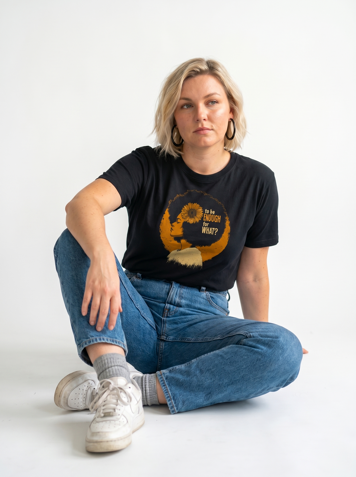 gravisk To Be Enough for What? organic graphic tee. Amber profile with a sunflower blooming from the head, TO BE ENOUGH FOR WHAT?