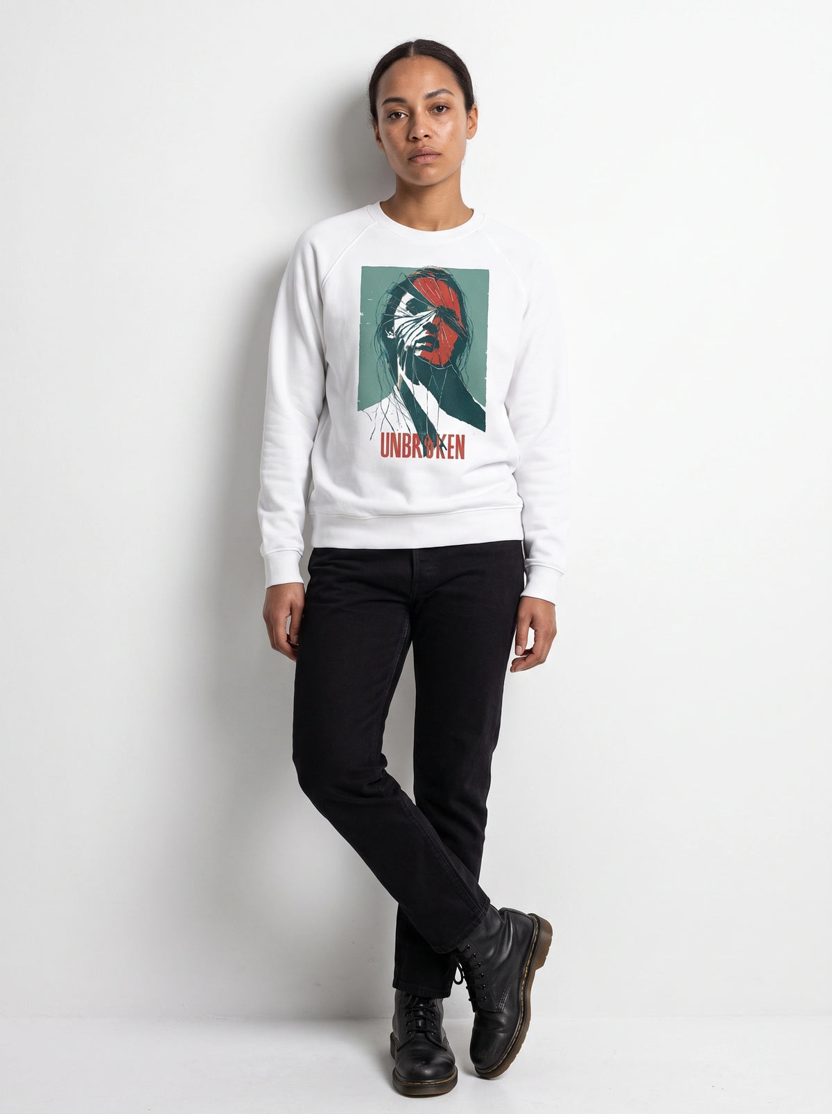 gravisk Unbroken graphic sweatshirt in organic cotton. Portrait split like shattered glass in teal and red with the word unbroken.