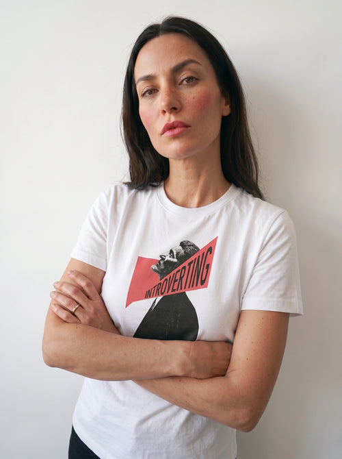 gravisk Introverting organic graphic tee. A tilted profile portrait cut by a red diagonal band reading INTROVERTING.