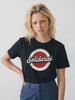 Person wearing a black t-shirt with 'Solidarité' graphic design on a plain background
